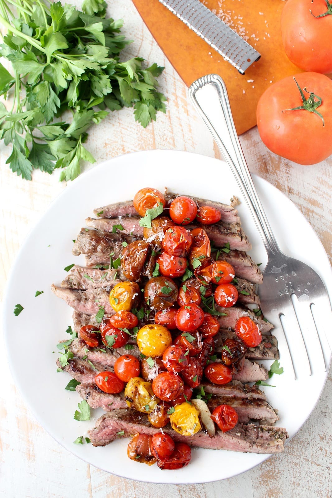 https://whitneybond.com/2016/11/09/italian-flank-steak-with-roasted-cherry-tomatoes/italian_flank_steak_recipe_6/