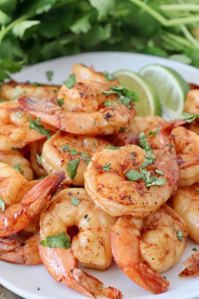 grilled shrimp on plate with lime wedges