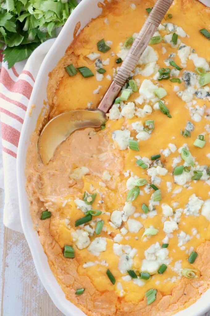 buffalo chicken dip in baking dish with serving spoon