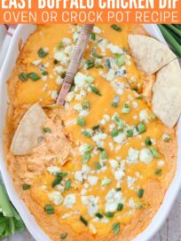 buffalo chicken dip in oval baking dish with tortilla chips