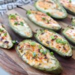 grilled jalapeno poppers on wood cutting board
