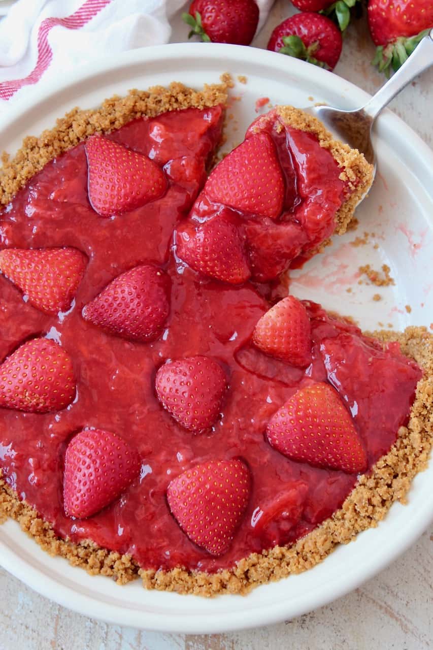 Slice being lifted out of strawberry pie