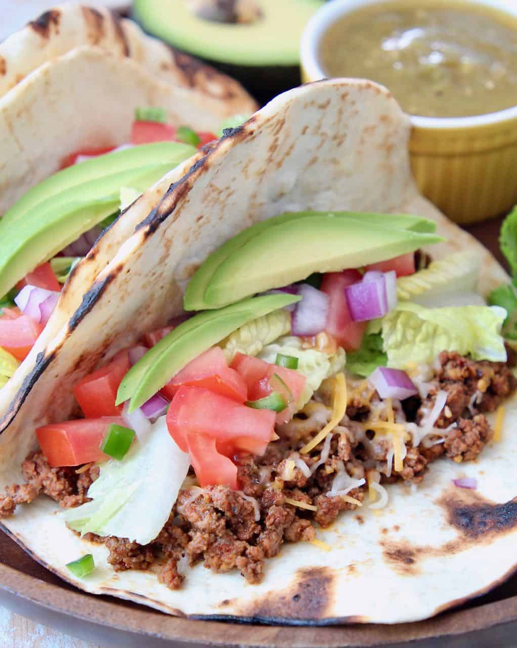 Ground beef tacos with avocado and tomatoes