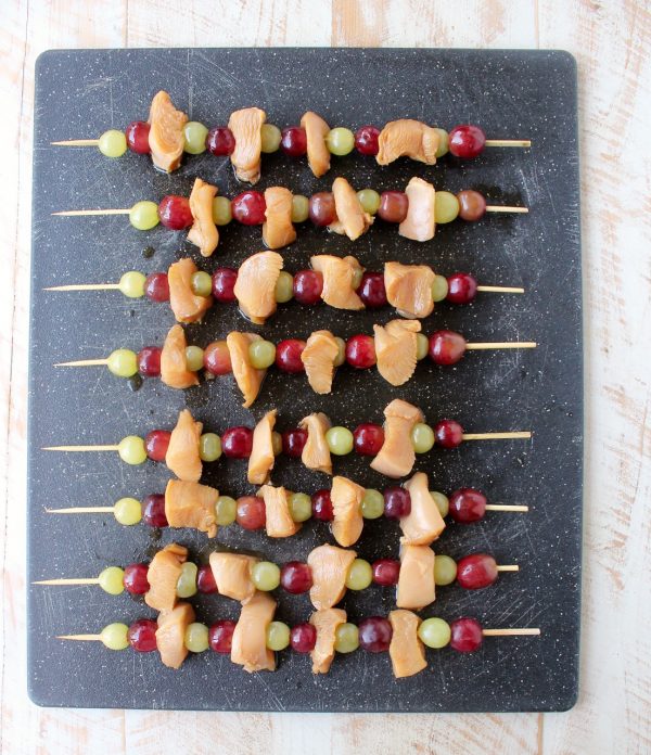 Skewers of marinated chicken & grapes are served with creamy peanut sauce in this Peanut Butter and Jelly Chicken Skewer recipe that's both fun & delicious!