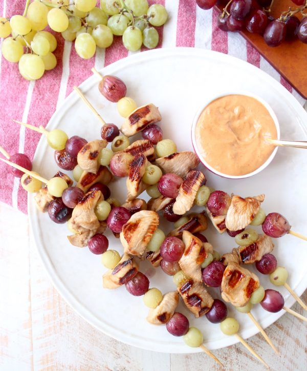 Skewers of marinated chicken & grapes are served with creamy peanut sauce in this Peanut Butter and Jelly Chicken Skewer recipe that's both fun & delicious!