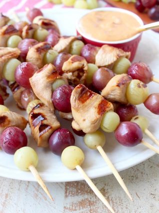 Skewers of marinated chicken & grapes are served with creamy peanut sauce in this Peanut Butter and Jelly Chicken Skewer recipe that's both fun & delicious!