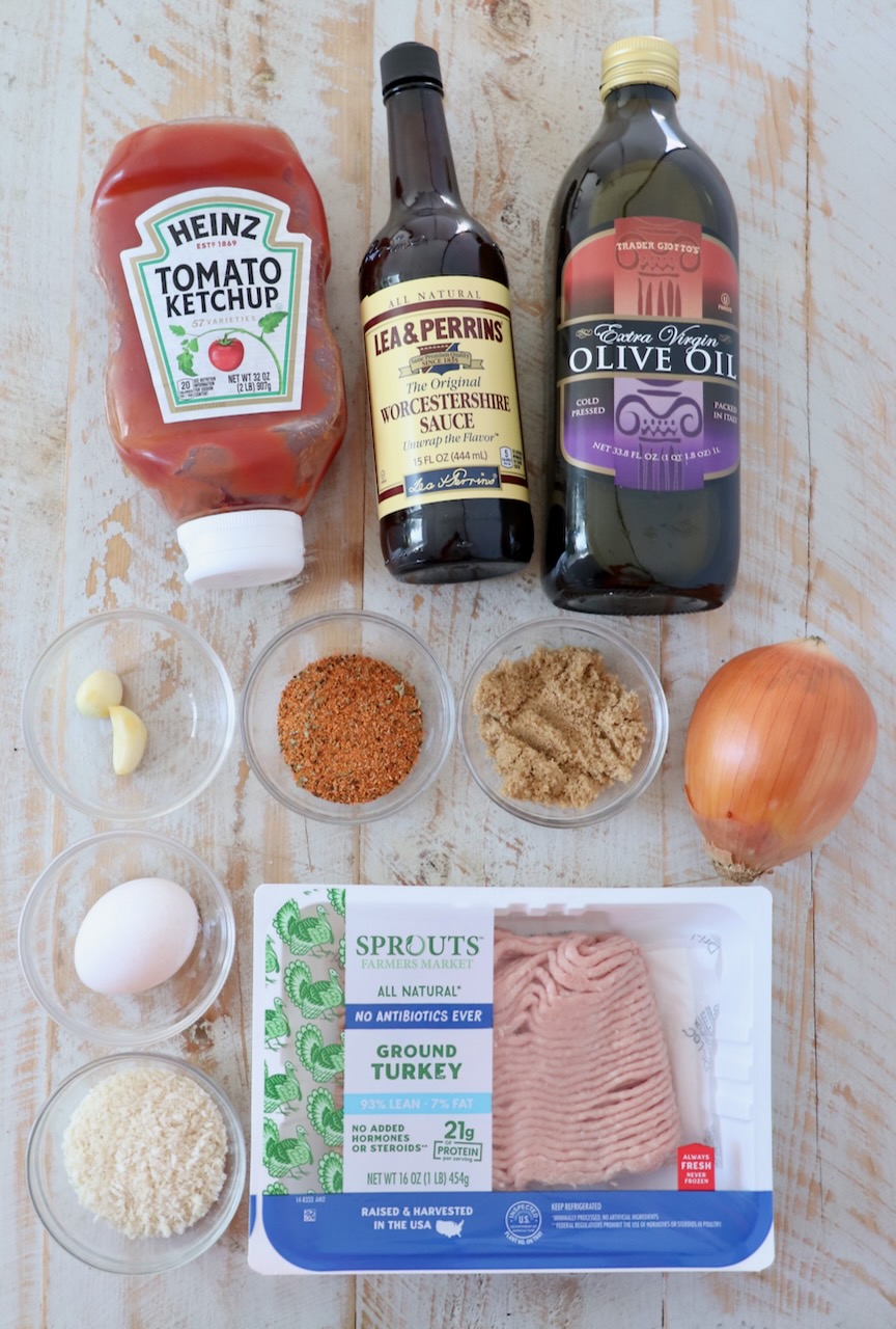 ingredients for mini meatloaves on a white wood board