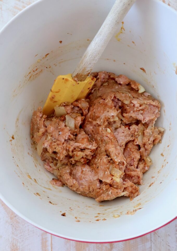 ground turkey mixed with spices, breadcrumbs and egg in a large mixing bowl