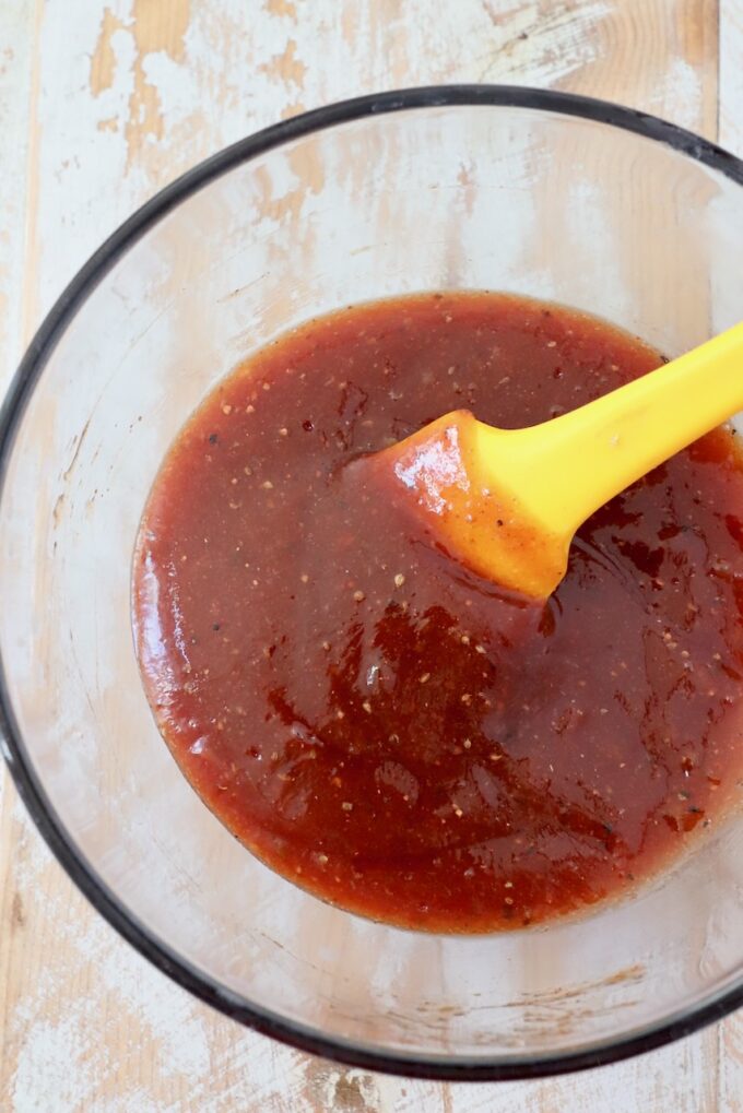 homemade bbq sauce mixed up in small glass bowl with spatula