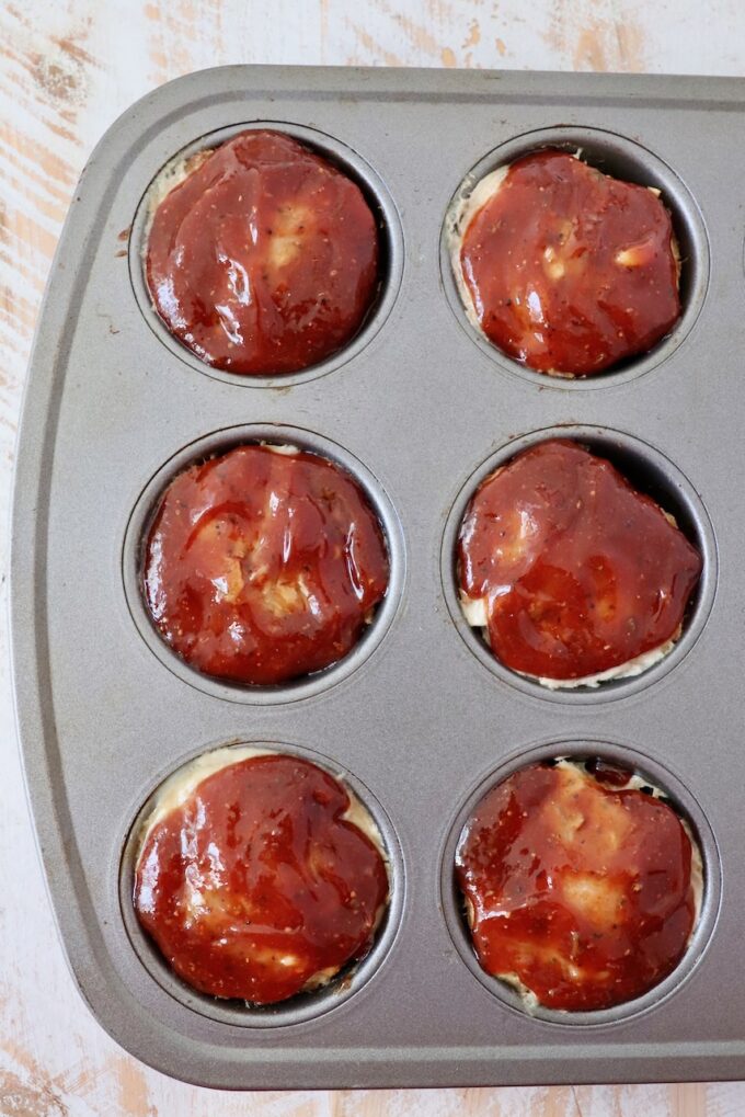 bbq glazed mini meatloaves in a muffin tin
