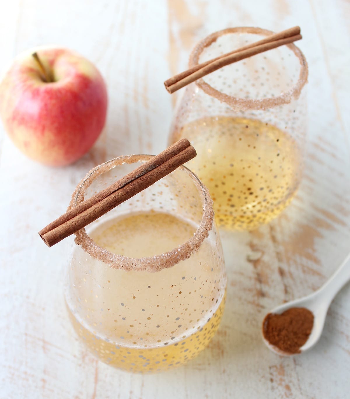 Rich apple cider is paired with sparkling champagne, vodka, maple syrup, cinnamon and nutmeg to make a festive fall apple cider champagne cocktail!