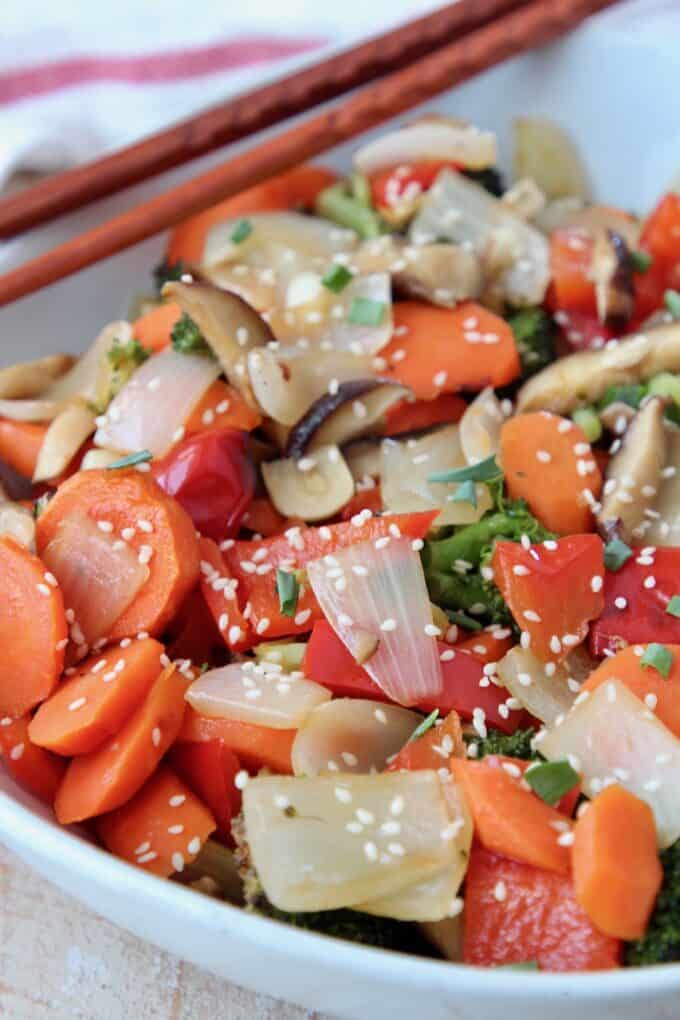 roasted vegetables in bowl with chopsticks