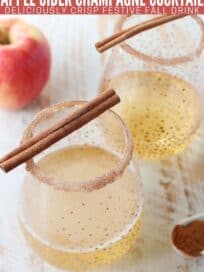Overhead image of champagne cocktail in glass topped with cinnamon sticks