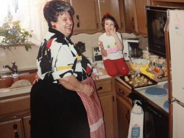 grandma and granddaughter in kitchen baking cookies