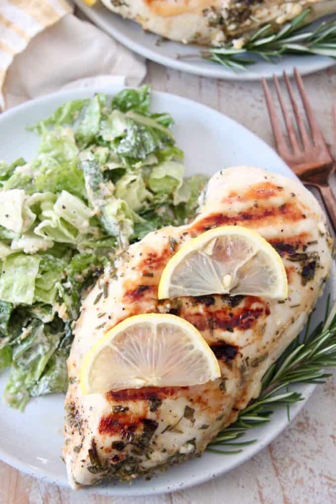 overhead image of chicken breast with slices of lemon
