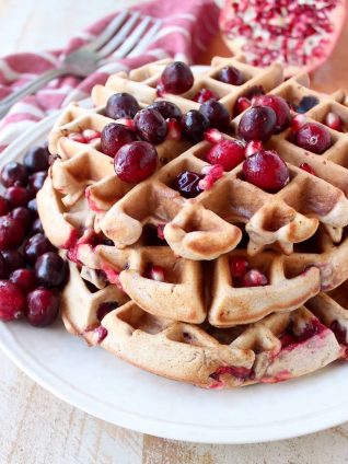 Fresh cranberries & pomegranates add a delicious burst of tartness & sweetness to this easy waffles recipe, perfect for fall breakfast or holiday brunch!