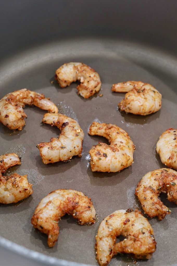 seasoned shrimp cooking in pan
