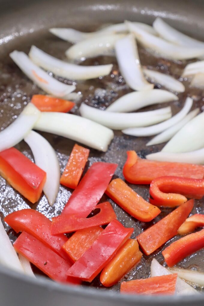sliced vegetables cooking in skillet