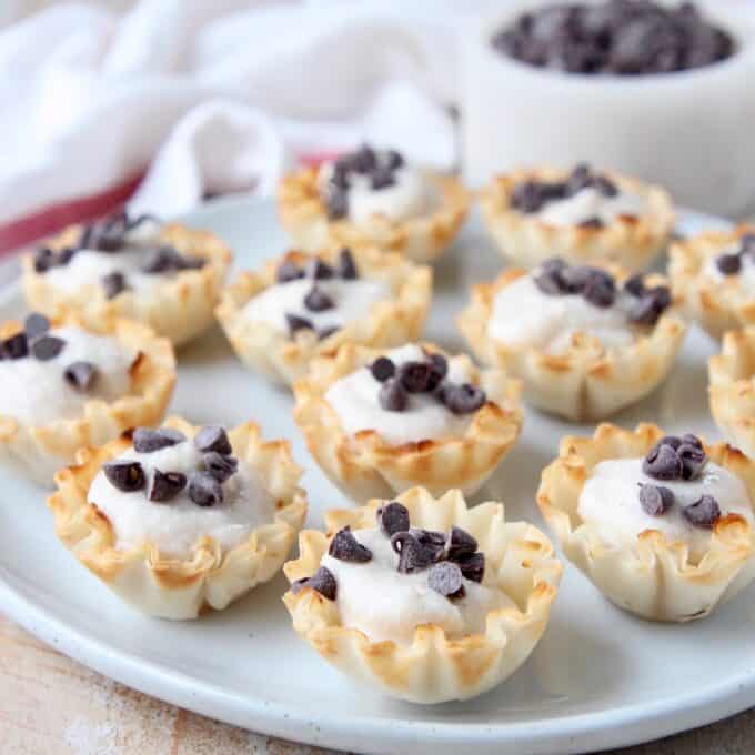 mini cannoli cups topped with mini chocolate chips on plate