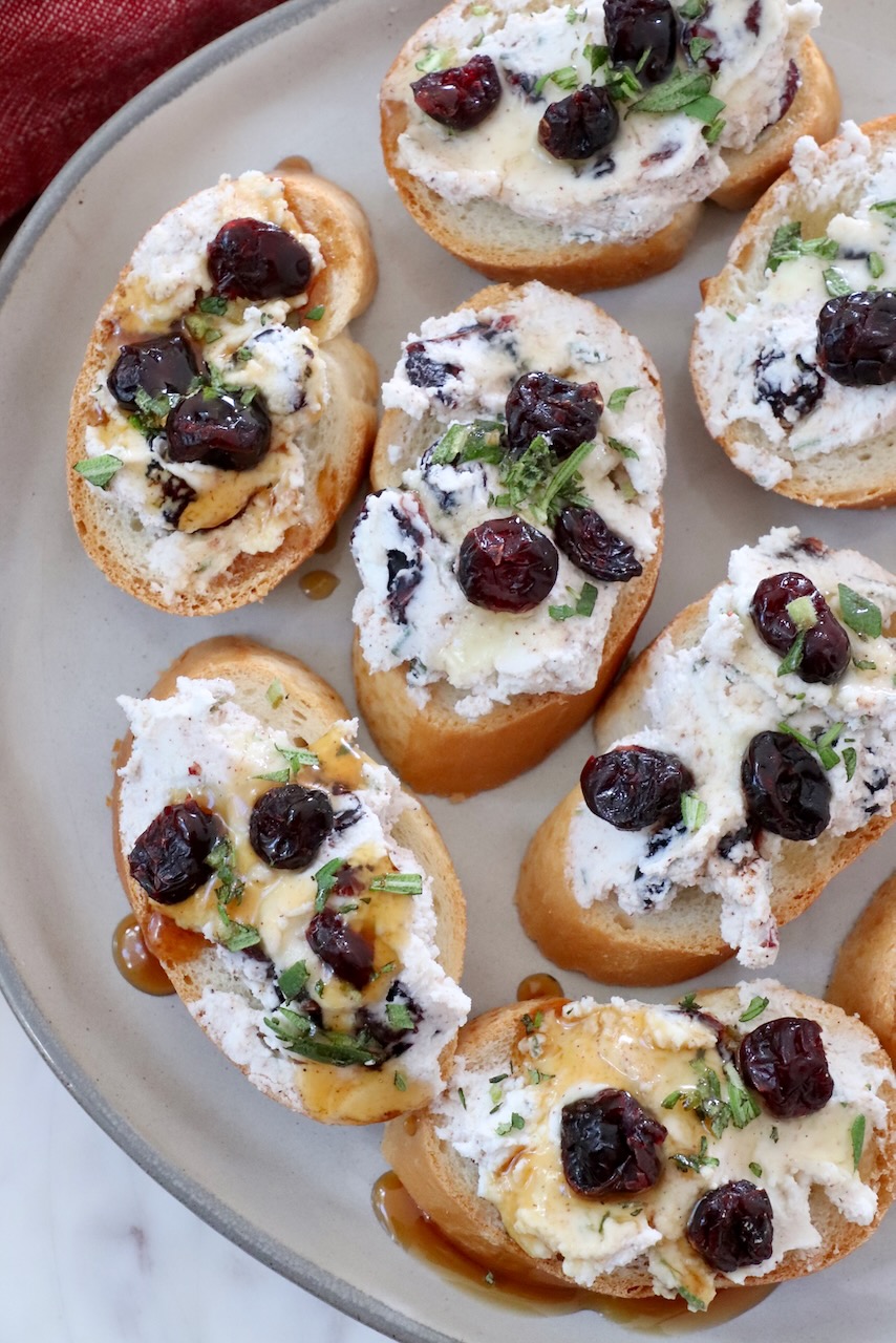 cranberry goat cheese crostini on a plate