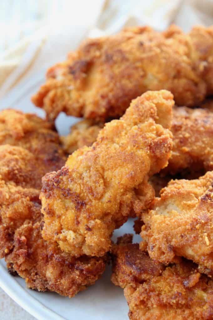 Stacks of fried chicken strips on plate