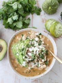 This flavorful Green Chili Chicken Enchilada Soup made with roasted chilies, tomatillos, fresh herbs & chicken is sure to be your new favorite soup recipe!