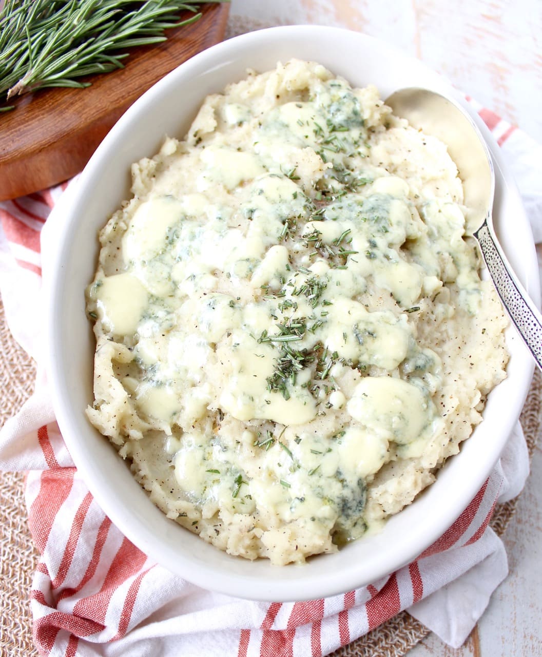 mashed potatoes in bowl with large spoon