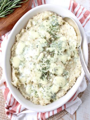 Warm rosemary herb infused butter is added to these blue cheese mashed potatoes for the best potato side dish you'll ever have in your life!