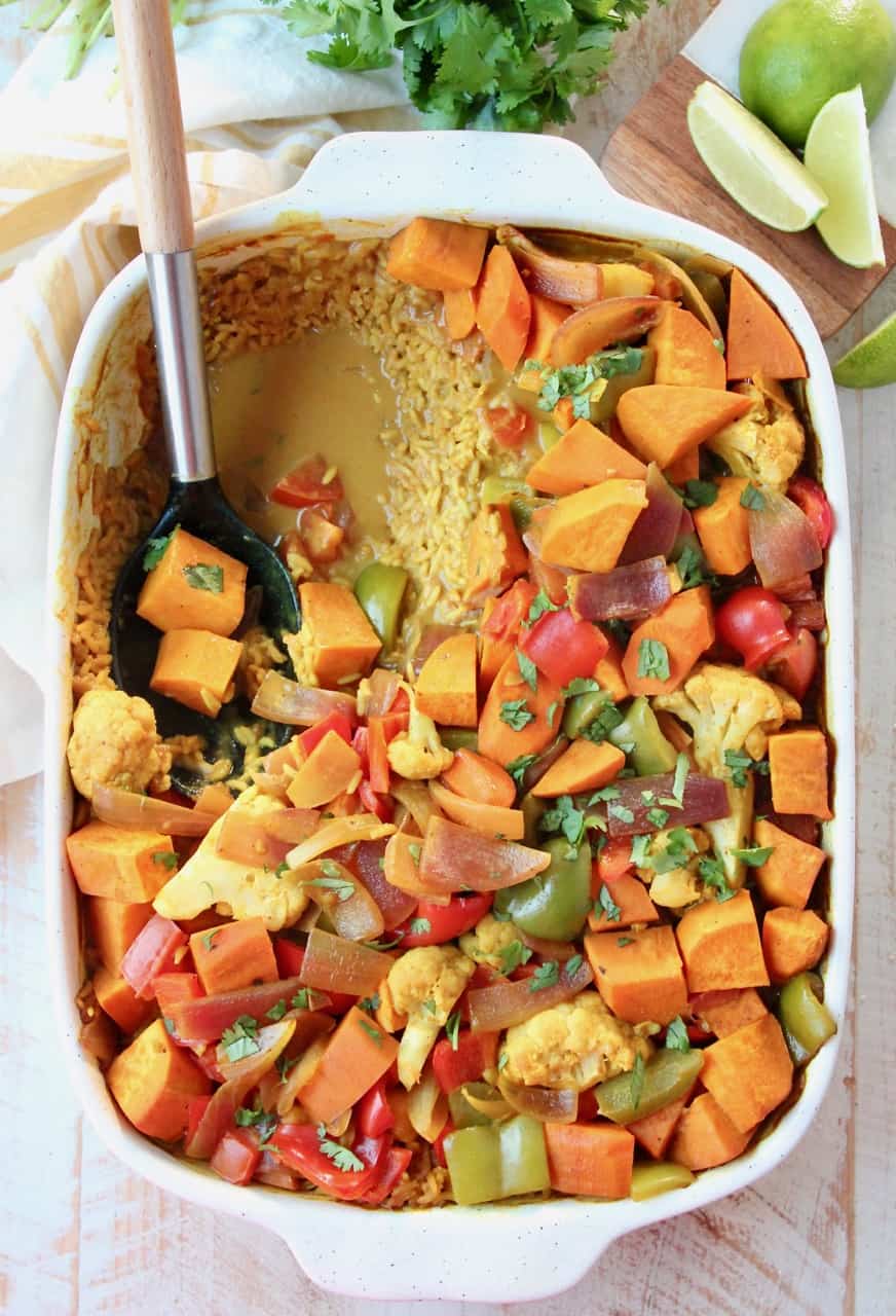 overhead image of curry casserole in dish with serving spoon