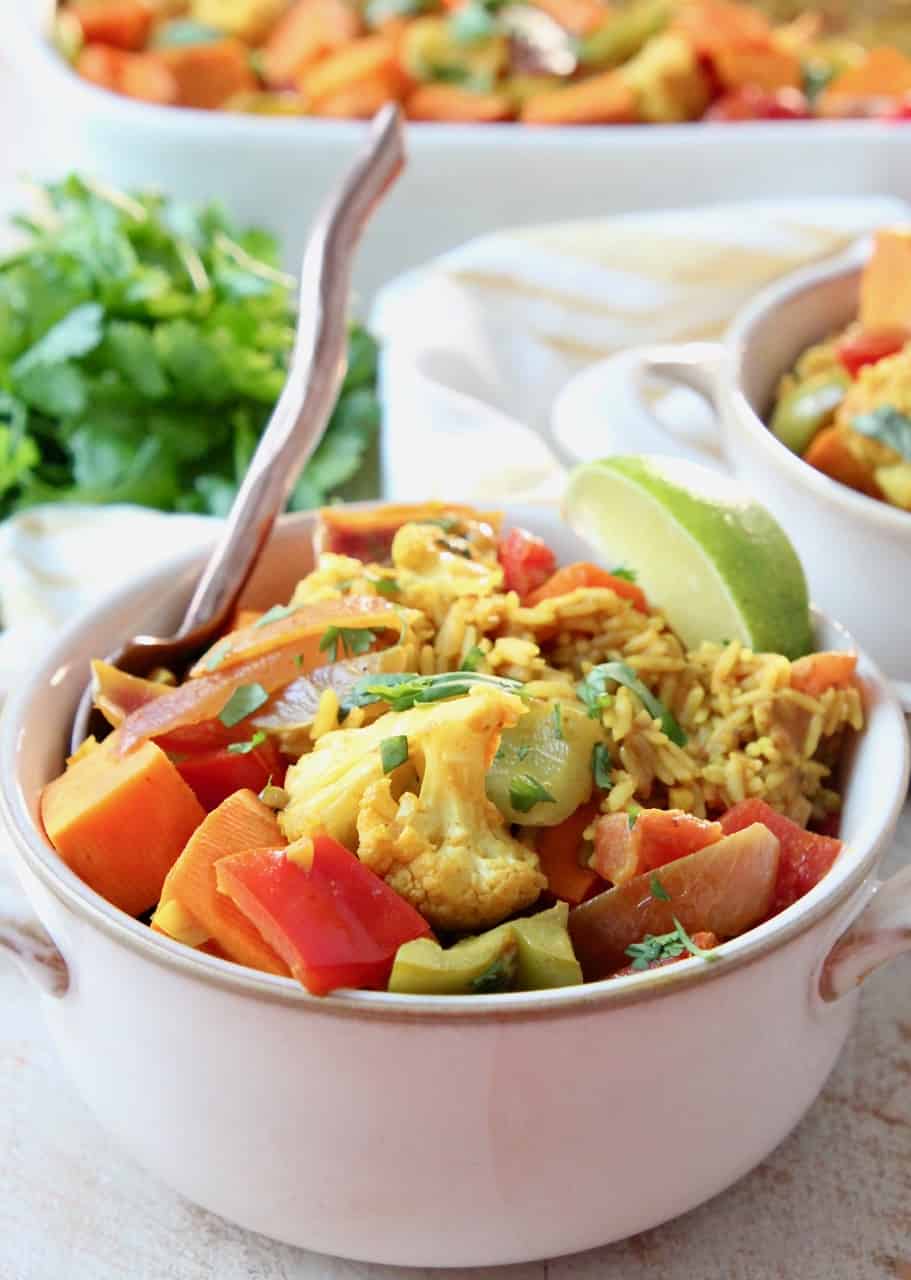 curry casserole with vegetables and rice in bowl with fork