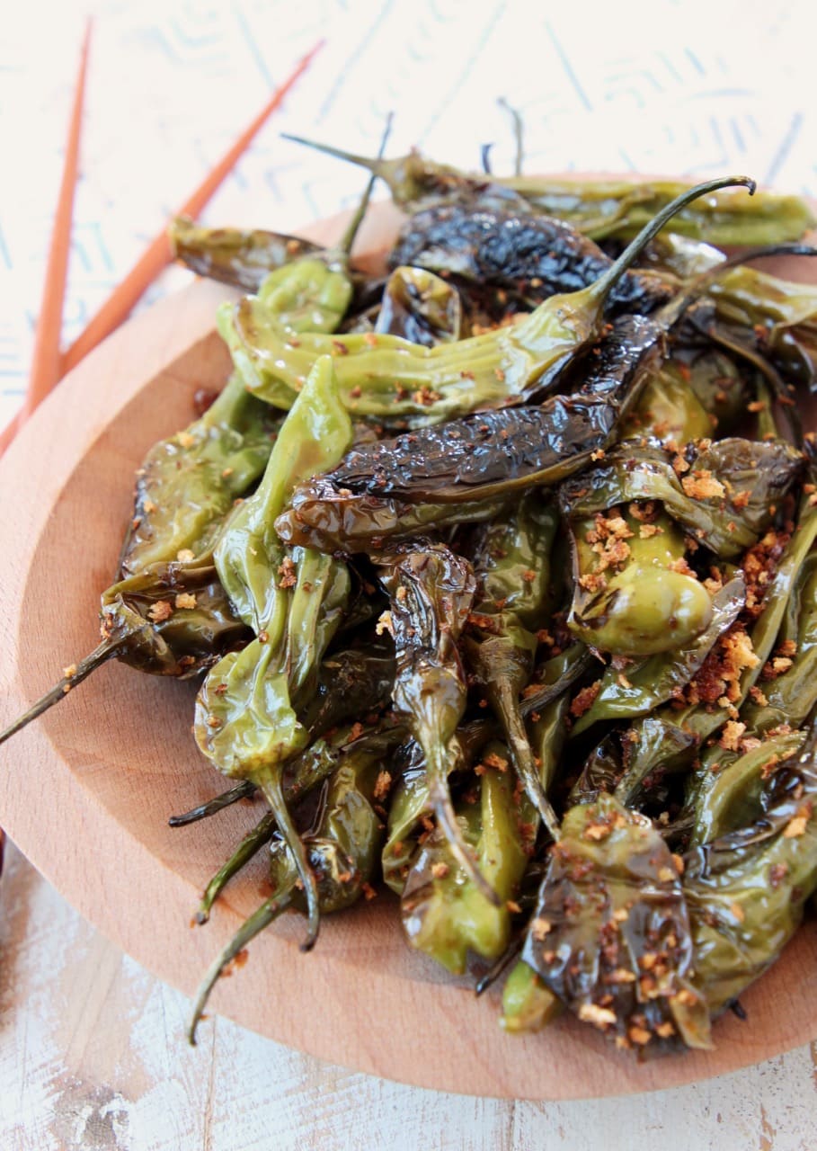 Shishito Peppers in Soy Ginger Sauce on Wooden Plate with Chopsticks