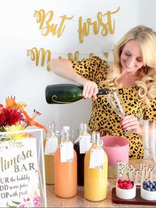 Woman pouring champagne into glass at a mimosa bar