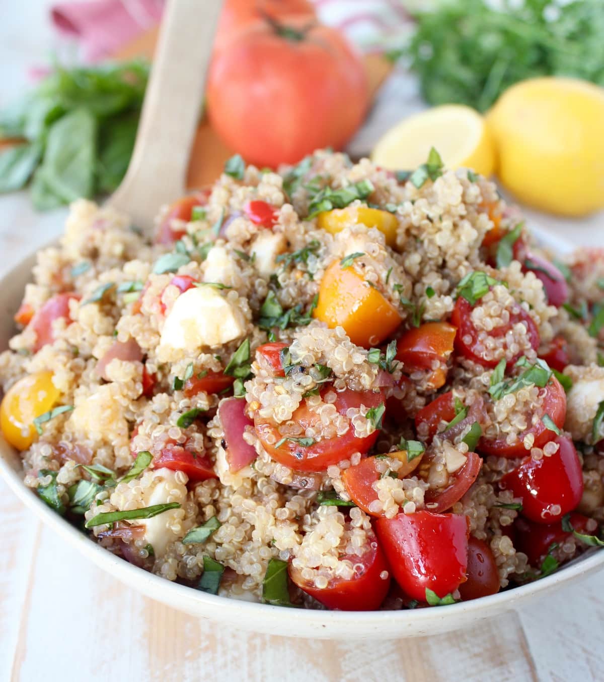 Quinoa Caprese Salad Recipe in a white bowl.