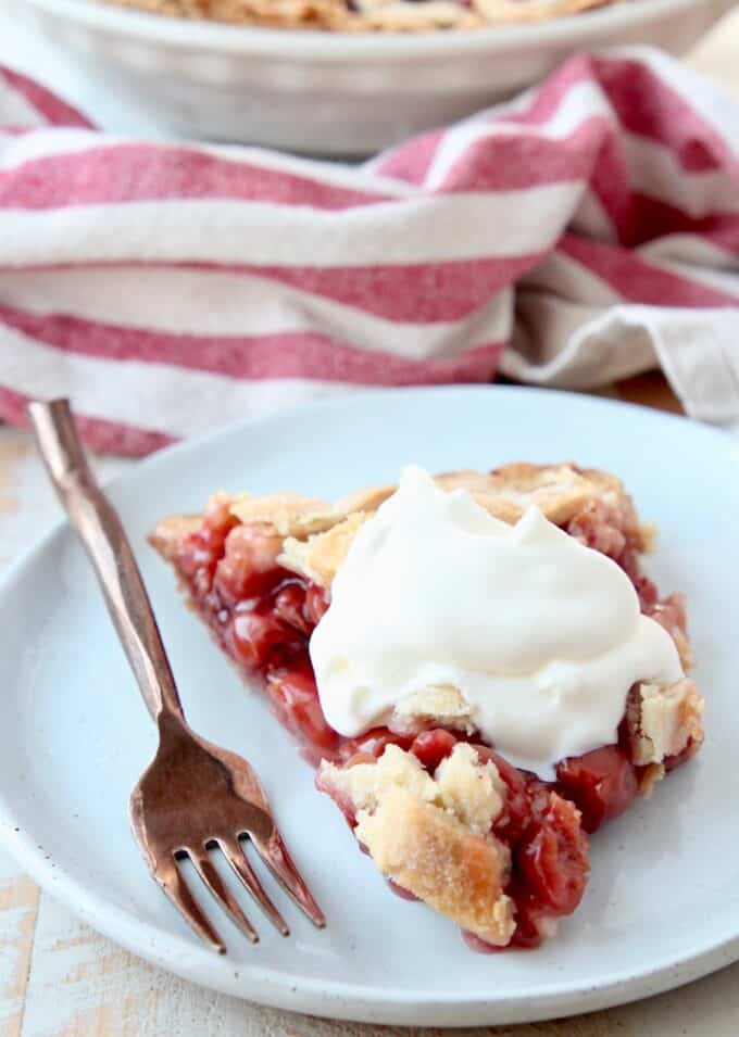 piece of pie on plate topped with whipped cream