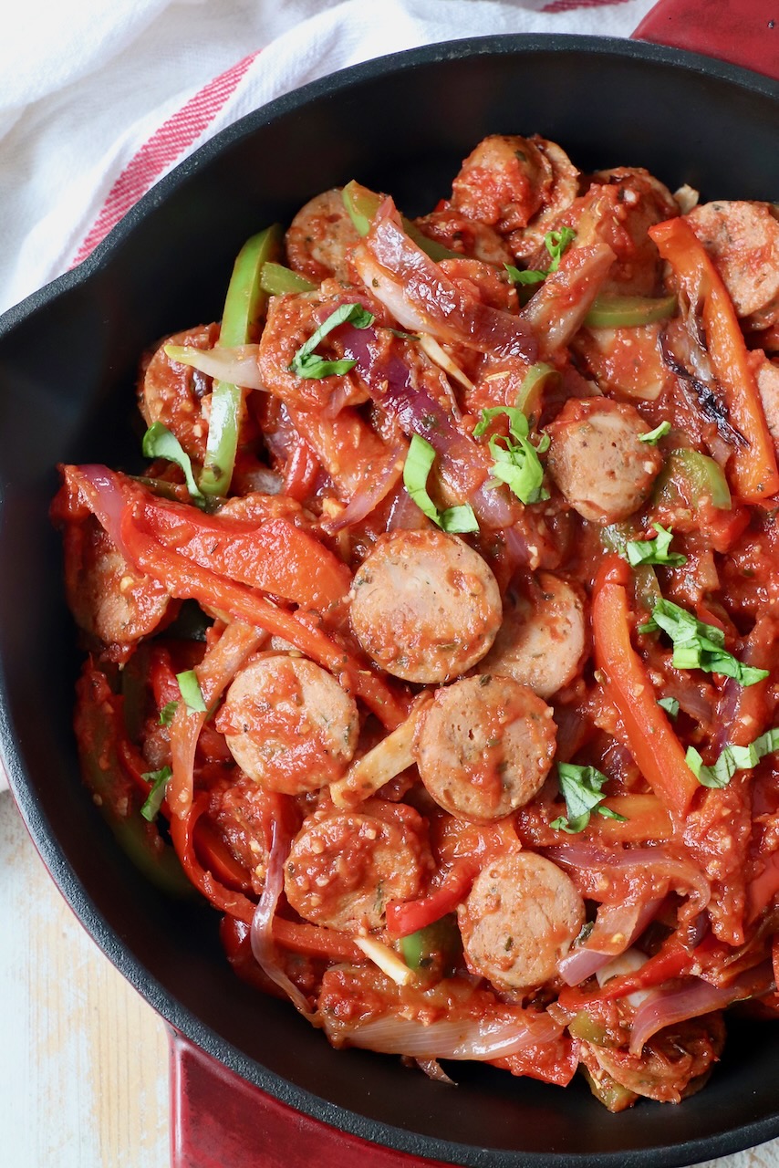 sliced sausage and peppers in tomato sauce in skillet