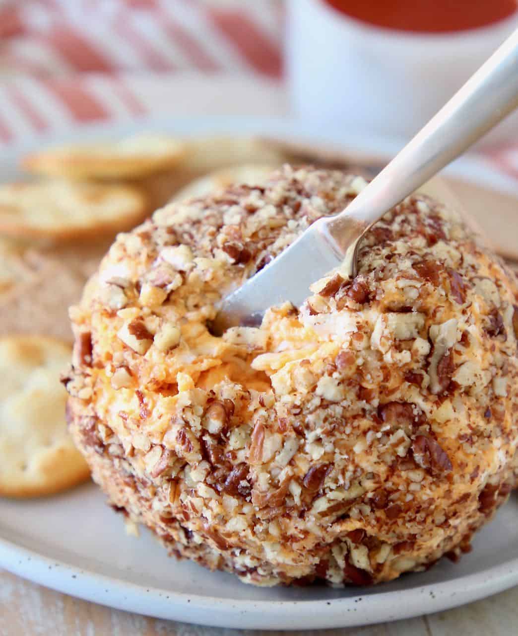 Cheese ball with cheese knife stuck in it