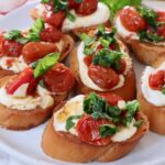 whipped ricotta and roasted tomato bruschetta on a plate