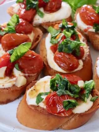 whipped ricotta and roasted tomato bruschetta on a plate