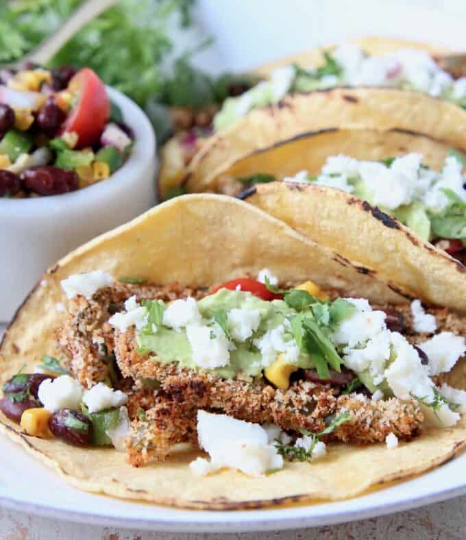Tacos on plate filled with crispy cactus strips and crumbled queso fresco
