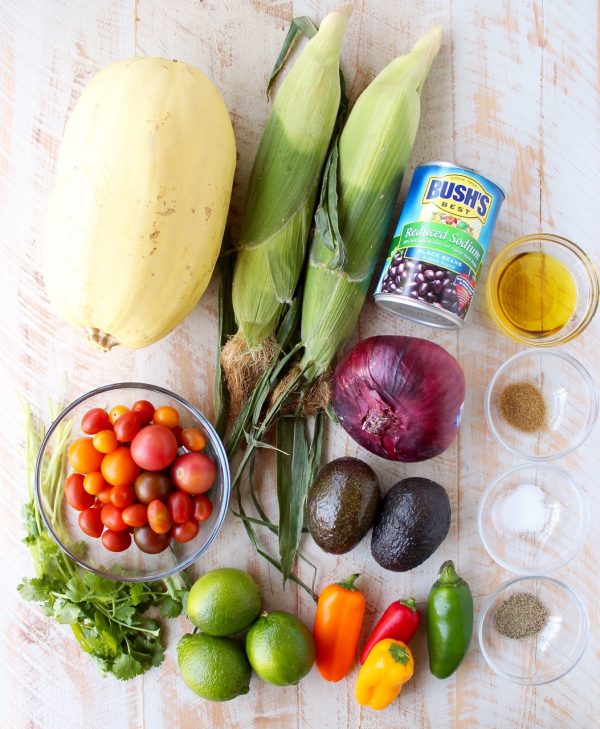 This Mexican Stuffed Squash recipe combines roasted spaghetti squash with black bean corn relish & avocado dressing for a simple vegan & gluten free meal!