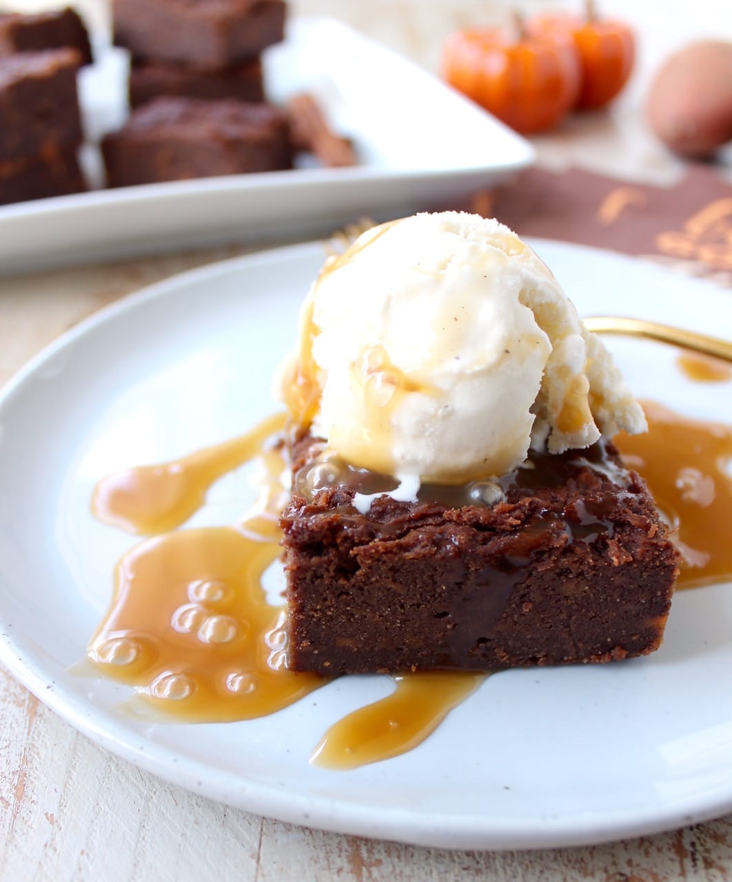 Gluten Free Sweet Potato Brownies are a rich and creamy treat, perfect for fall, topped with vanilla bean ice cream and drizzled with caramel syrup!