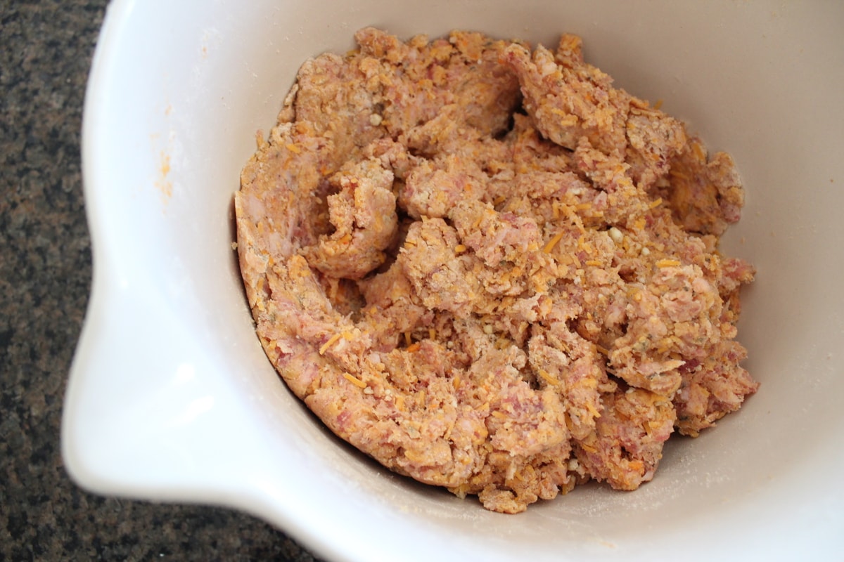 Sweet Potato Sausage Balls mixture in a white bowl. 