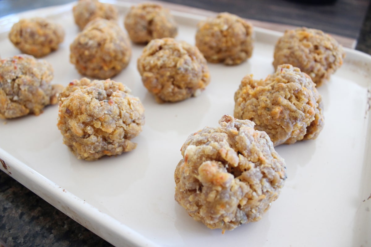 Cooked Gluten Free Sausage Balls on a baking sheet.