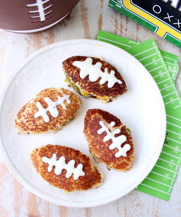 This grilled cheese sandwich recipe is filled with all of the ingredients that make a delicious jalapeño popper, cut into football shapes for game day!