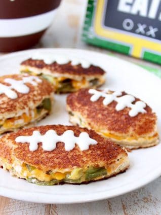 Jalapeno popper grilled cheese sandwiches in the shape of a football