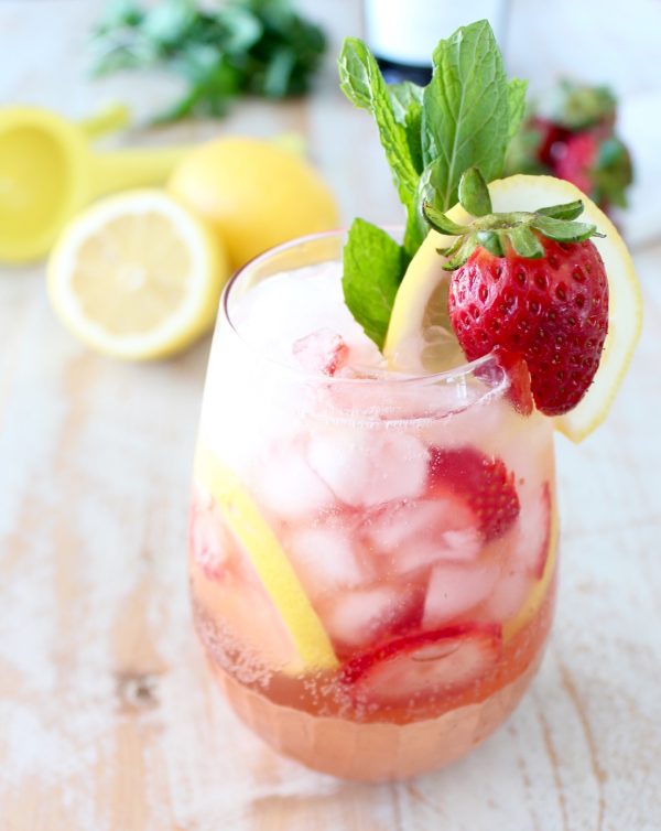 strawberry lemon prosecco sangria in stemless wine glass