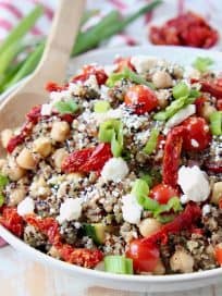 Quinoa salad in bowl with feta cheese, sun dried tomatoes and chickpeas