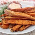 Sweet potato fries stacked up on plate