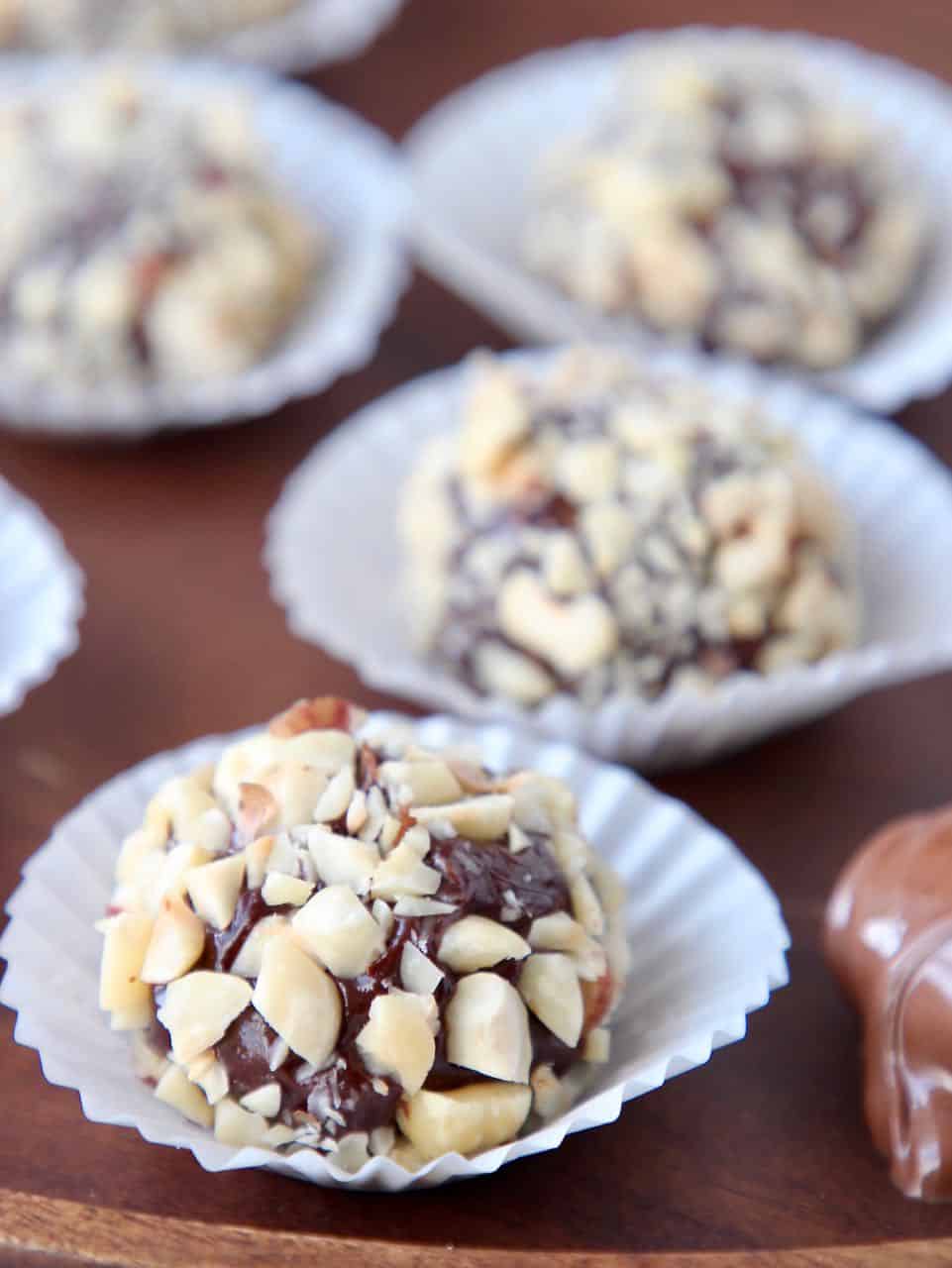 Hazelnut chocolate truffles in white candy paper cups 