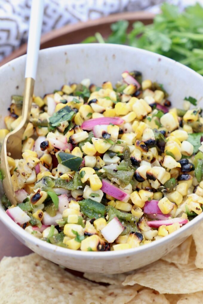 corn salsa in white bowl with spoon